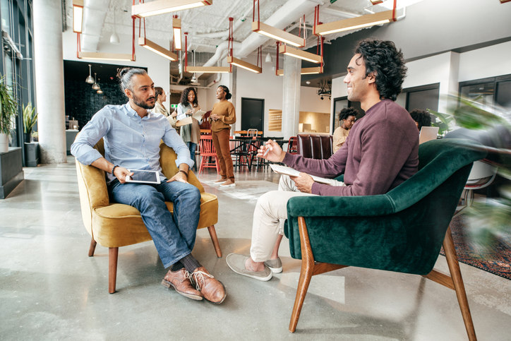 two-men-sitting-across-from-each-other-having-a-conversation