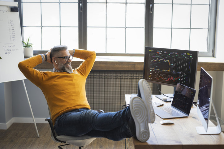 a-man-sitting-at-a-desk-with-his-feet-up-on-the-desk