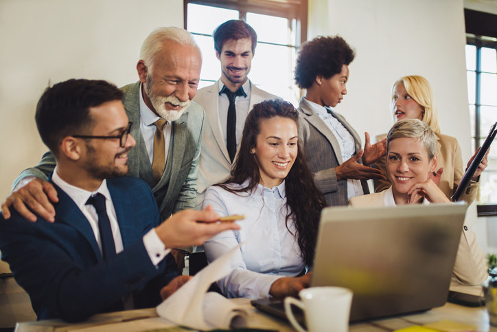 happy-employees-looking-at-computer