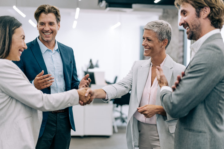 Group of employees shaking hands