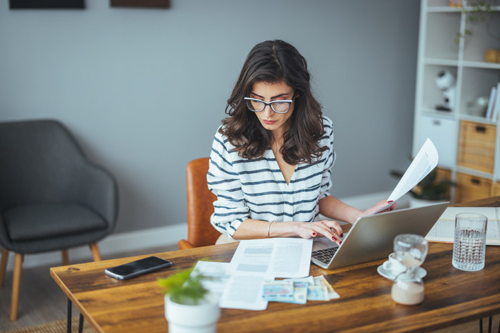 woman-sitting-at-a-desk-entering-information-into-a-computer