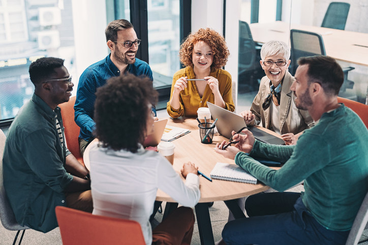 a-group-of-people-sitting-at-a-table-having-a-discussion