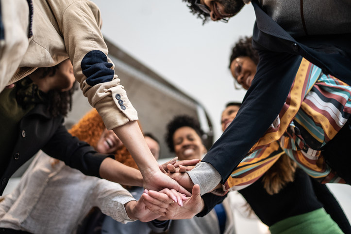 a-group-of-people-put-their-hands-in-the-middle-of-the-group