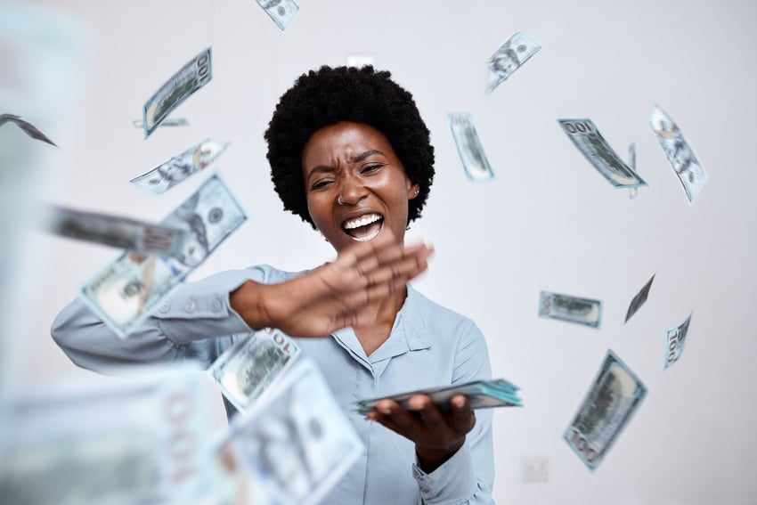 Woman throwing money, happy.