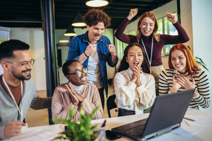 excited-employees-looking-at-computer