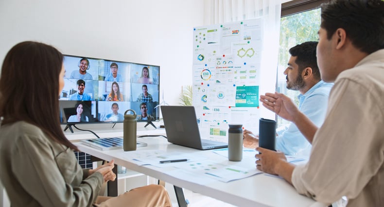 three-people-sitting-at-a-table-while-in-a-remote-meeting