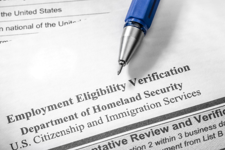 a-pen-rests-on-an-i-nine-employment-eligibility-verification-form