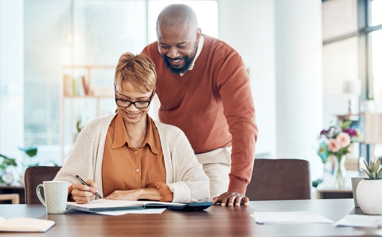 a-black-couple-look-at-papers-together-and-plan-their-finances