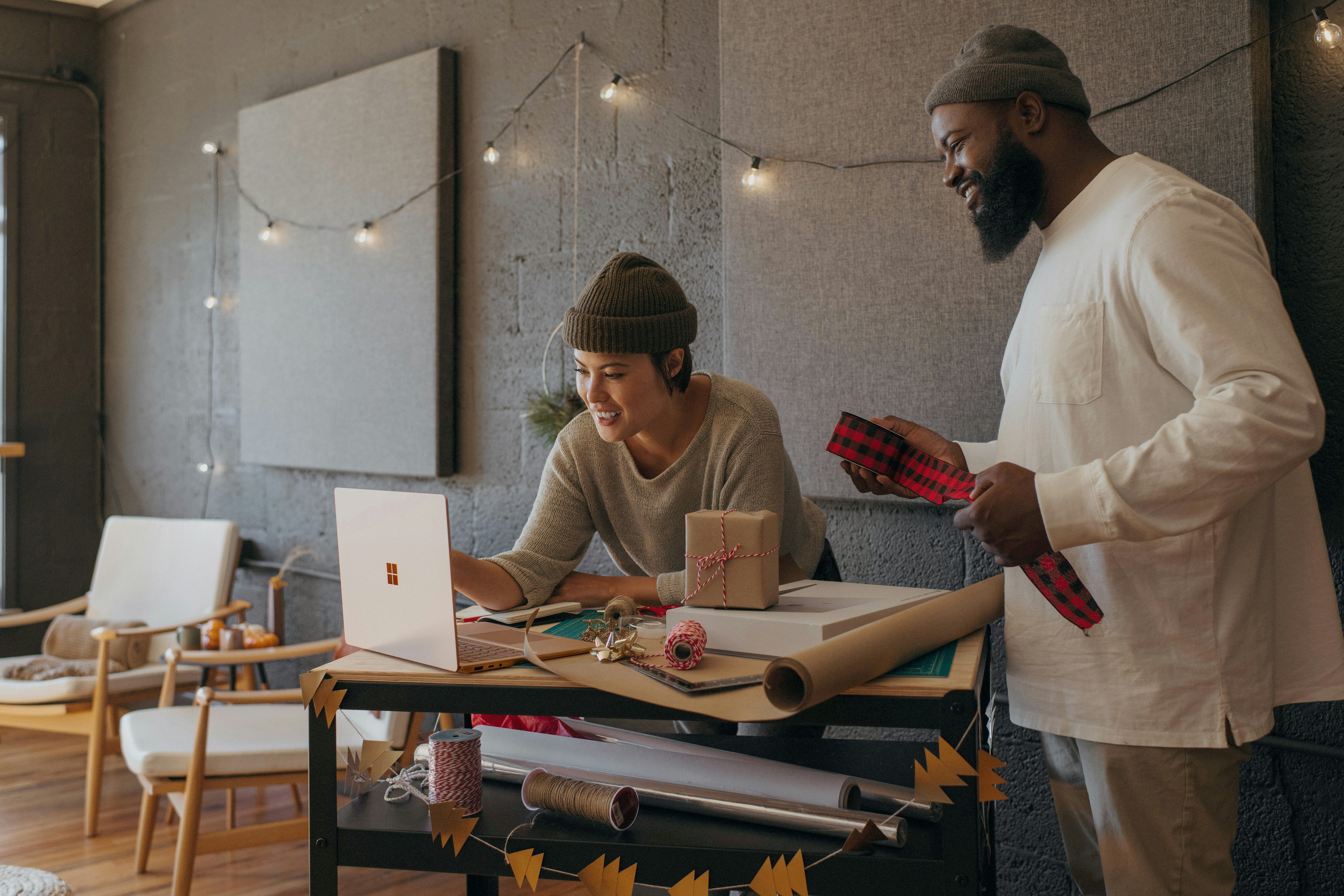 two-people-working-on-wrapping-gifts-in-an-office